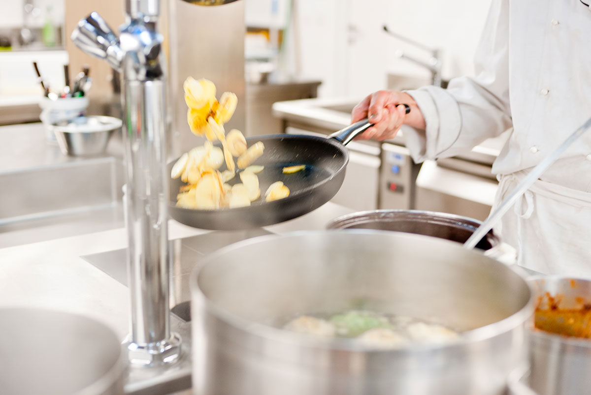 A chef preparing potatoes - Hotel Gasthof zur Sonne